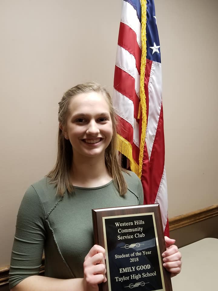 Emily Good holding plaque after receiving the Student of the Year award.